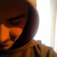 Pixar’s 3d style young man looking down with a white plush cap and brim front faced. Brown sweatshirt with hood and drawstring. Medium-sized beard all over the face. Shy laughter in the corner of his mouth. Gold hoop earring in the ear and black hoop piercing in the nose. Brown eyes and short hair. Skin is white and face is slightly rounded. Diagonal view facing left.